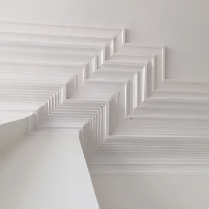 Detail van het plafond met witte plafondlijsten